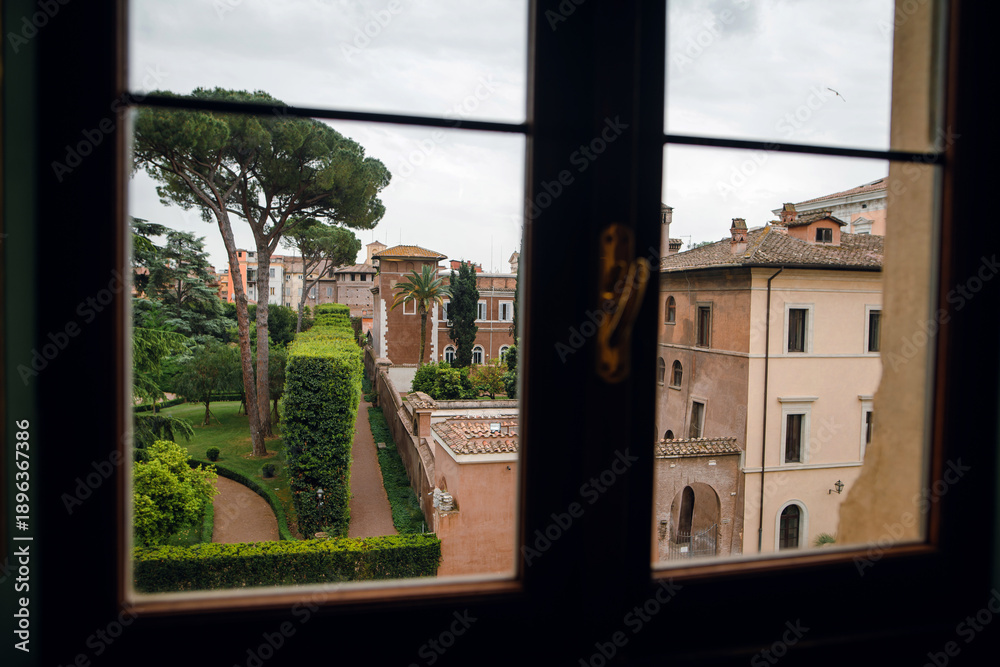 Naklejka premium View of Roman Garden Through Window