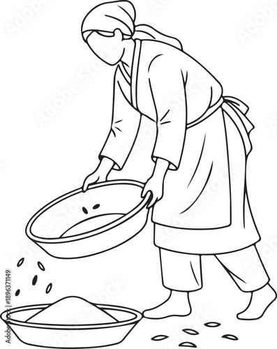 Woman winnowing grain in traditional style, separating husks from edible seeds
