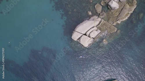 aerial view of stones and boat- top drone view