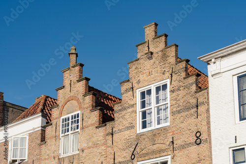 Quaint architecture with intricate brickwork details and clear sky.