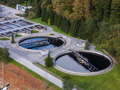 Canvastavla Aerial view of wastewater treatment infrastructure with circular tanks and basins located in a natural environment, emphasizing sustainable water management