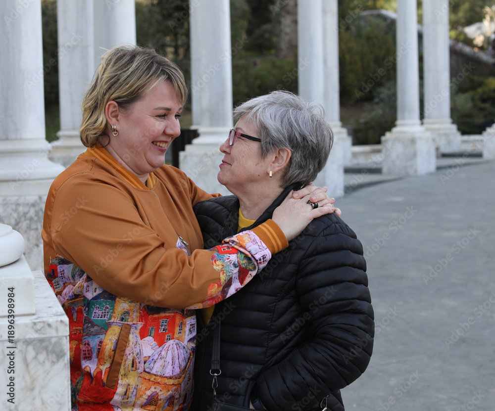 Fototapeta premium Portrait of a adult daughter and senior mother, care, support and relationsheep between generations