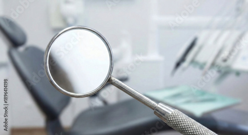 Stainless steel dental inspection mirror tool close up in clinic