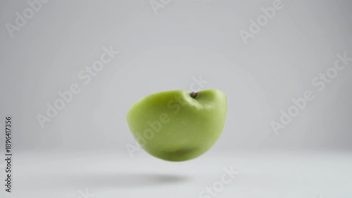 Wallpaper Mural Dynamic Green Apple Halves Rotating on Clean Background for Healthy Eating Concept Torontodigital.ca