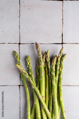 Asparagus spears photographed in a close arrangement with minimal food styling. Fresh green vegetables shown as raw ingredients, ideal for clean eating, vegetarian and plant-based food concepts.