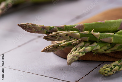 Close-up view of fresh green asparagus tips highlighting natural texture and color. Raw seasonal vegetables suitable for healthy eating, fresh produce and food ingredient concepts.