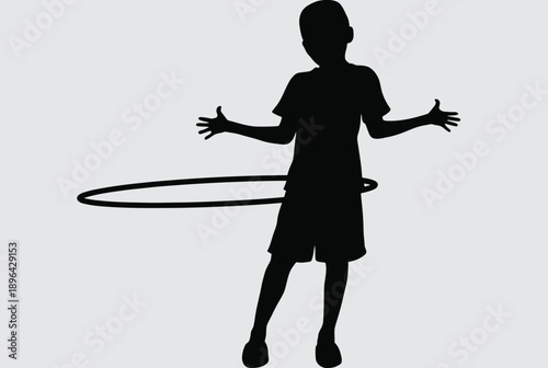 A silhouette of a young boy playing with a hula hoop in a fun and carefree moment.