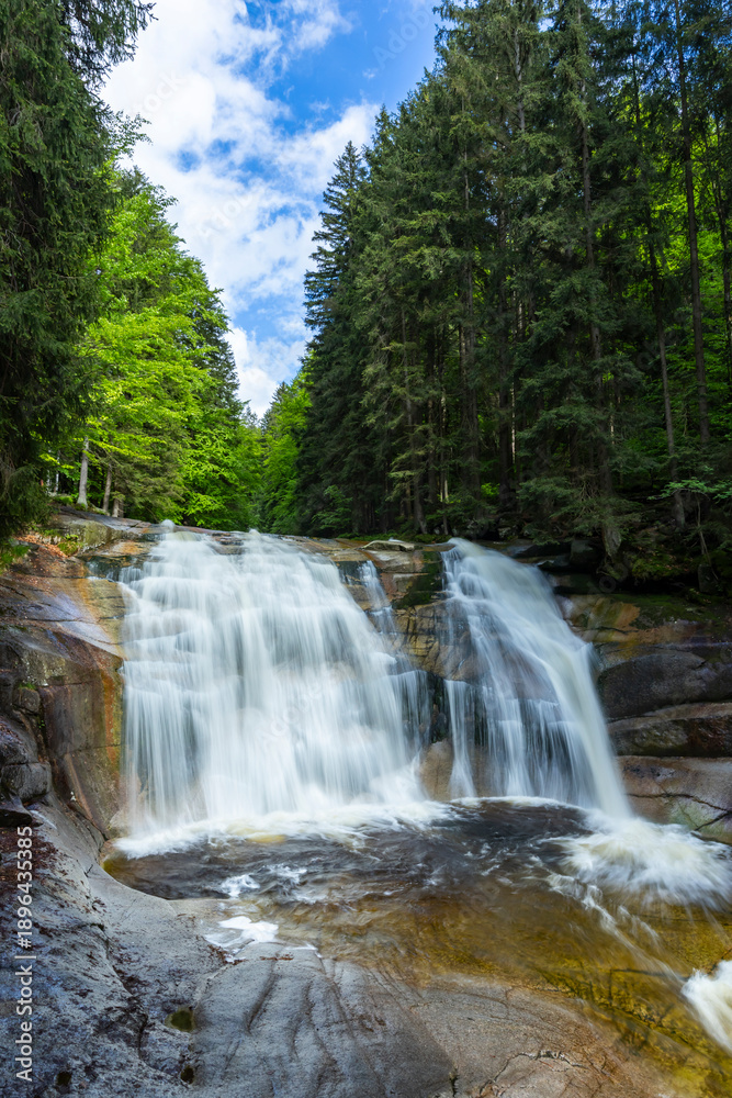 Fototapeta premium Mumlava waterfall in Harrachov flowing through forest