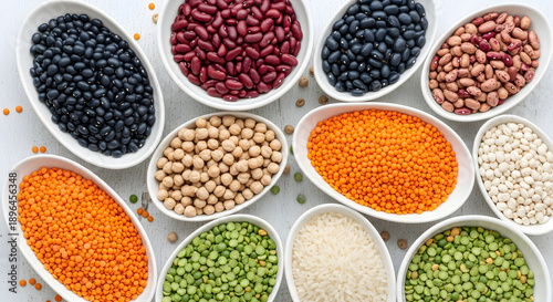 Variety of colorful legumes and pulses displayed in white bowls