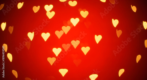 A vibrant red background with numerous small golden hearts floating around