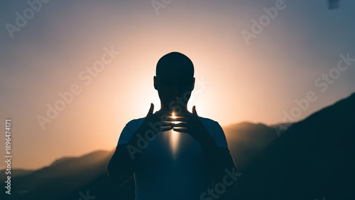 silhouette of person with glowing heart light at sunset, mindfulness and self love concept, mental health wellness and inner peace on peaceful mountain horizon