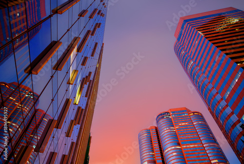 Skyscrapers tower bright glass exteriors sunlight sunset. Facade office buildings. High-rise bank building. Hong Kong Central Business District. Glass facade skyscraper building. HK commercial realty.