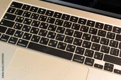 Closeup view of a laptop keyboard featuring Cyrillic characters, highlighting technology and typography details