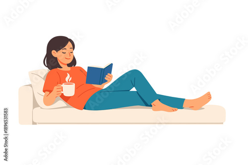 Woman relaxes on sofa while reading a book and enjoying a warm drink during a leisurely afternoon at home