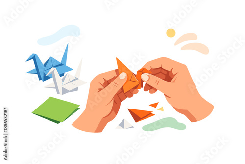 Hands working on orange origami craft with folded paper shapes in background and bright colors present in the workspace