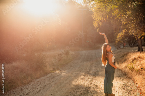 girl in sunlight walking on path