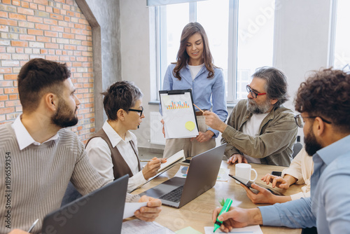 Tableau sur toile Group of multi generational business people meeting in an office, working togeth