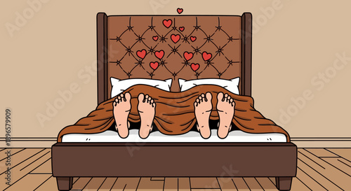 Couple lying in bed together under the covers with hearts on the headboard in a cozy bedroom