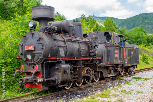 Historic steam locomotive displayed on railway tracks, representing vintage train technology, industrial heritage, classic transportation, and historical rail engineering.