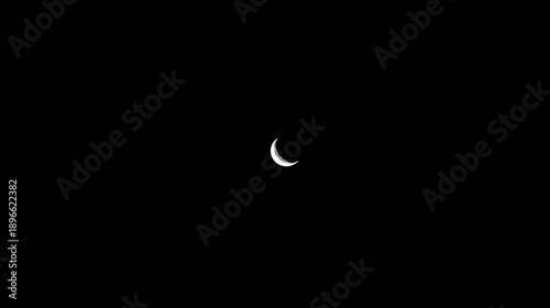 A crescent moon, subtly lit, resides in the vast, inky blackness. The focus is a celestial body