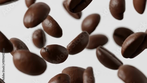 Brown coffee beans scattered and floating in mid-air against a plain white background. Perfect for food, beverage, and coffee-related marketing content.