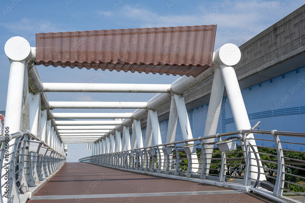 Naklejka premium Modern bridge structure with repetitive geometric patterns and industrial architecture details