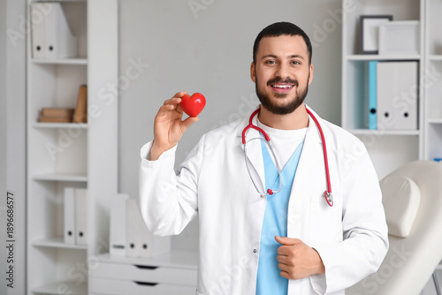 Young happy male doctor wit...