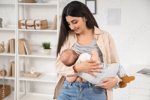 Young woman breastfeeding h...