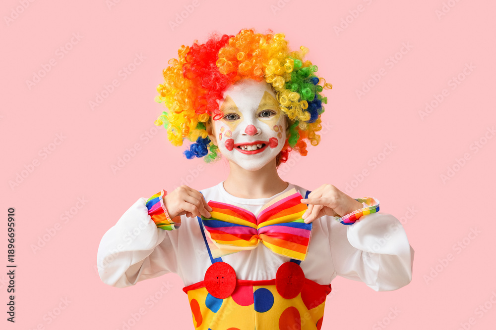 Fototapeta premium Little girl in clown costume on pink background. April Fools' Day celebration
