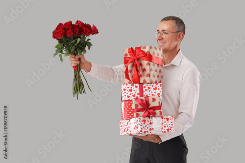 Happy mature man with bouqu...