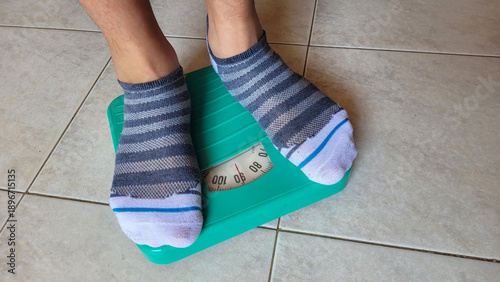 Canvas Print Person Weighing on Analog Scale with Striped Socks