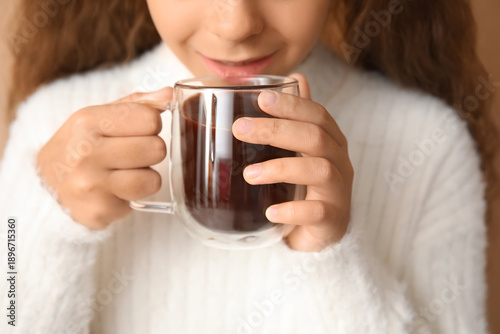 Cute girl with glass cup of...