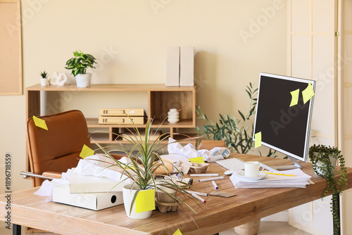 Messy workplace with comput...