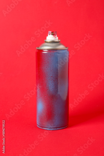 Spray paint can on red back...