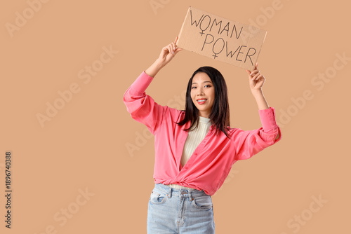 Young Asian girl holding pa...
