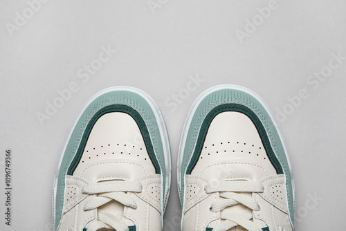 Stylish sneakers on grey ba...