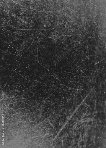 A dramatic black background heavily textured with white scratches, dust particles, and fine grain, creating a weathered, distressed look.