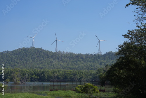 Wind turbines installed on lush green hills along the scenic route between Tirupati and Tirumala, Andhra Pradesh, India