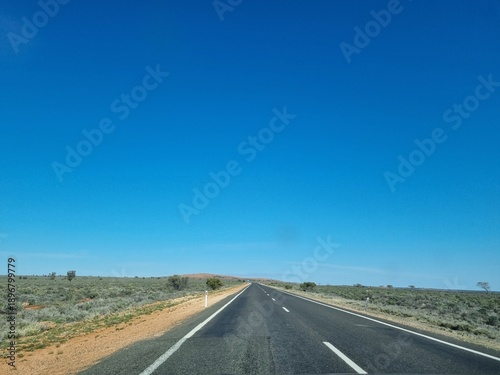 The Barrier Highway From Cobar to Broken Hill in the Australian Outback under a blue sky