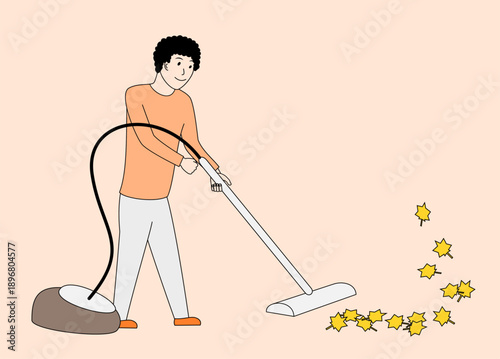Man is vacuuming leaves on the floor