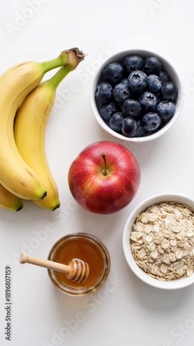 Wallpaper Mural Healthy Breakfast Ingredients with Oatmeal Blueberries Banana Apple and Honey on White Background Torontodigital.ca
