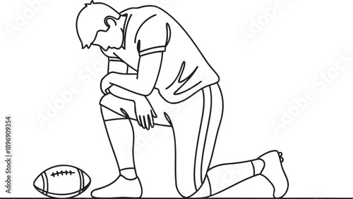 American football player kneeling down beside ball