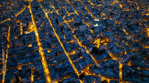 Fotografie Aerial Cityscape at Dusk with Illuminated Grid Streets