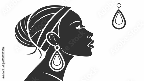 Silhouette of a woman wearing elegant teardrop earrings, facing right with flowing hair tied back