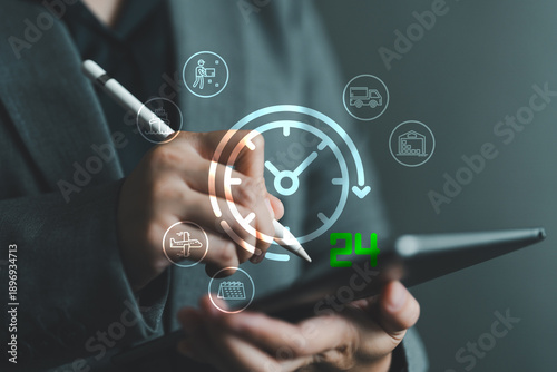 Business hand using digital tablet with glowing 24 hour delivery logistics. Concept of fast, real-time delivery, shipping, transportation, supply chain and warehouse automation management systems.