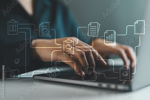 Close-up of business hands typing on laptop with virtual digital document workflow. Concept of paperless office, cloud-based document management, quality control and smart workflow automation.
