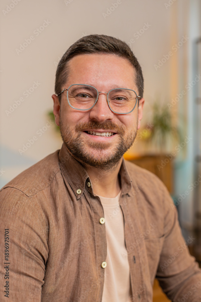Obraz premium Portrait of happy calm young businessman at home smiling friendly, glad expression looking dreaming resting, relaxation feel satisfied concept good news, celebrate win. Caucasian guy in living room