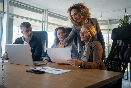 Business team of diverse professionals collaborating with ai laptop technology