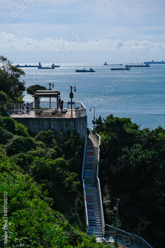 Busan coastal cityscape with harbor view, cargo ships, and bridges in South Korea.