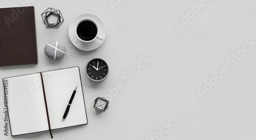 Overhead flat lay of a minimalist workspace with an open blank notebook, pen, coffee cup, and geometric desk accessories on a light gray background
